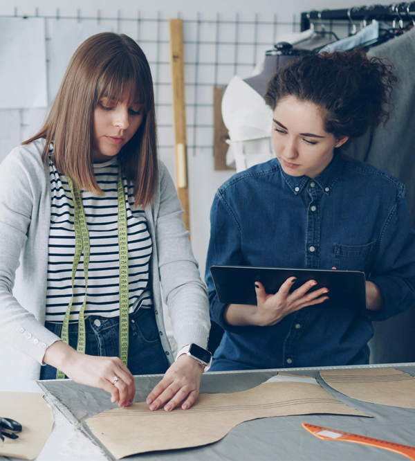 Tailors Crafting Garment Patterns in Studio